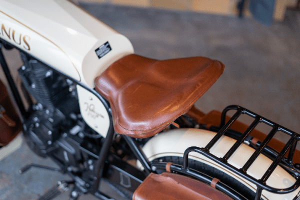 Close-up of a vintage motorcycle seat and part of the fuel tank.