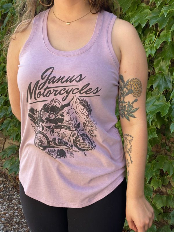 Woman wearing a Janus Motorcycles tank top with tattoos on her arm.