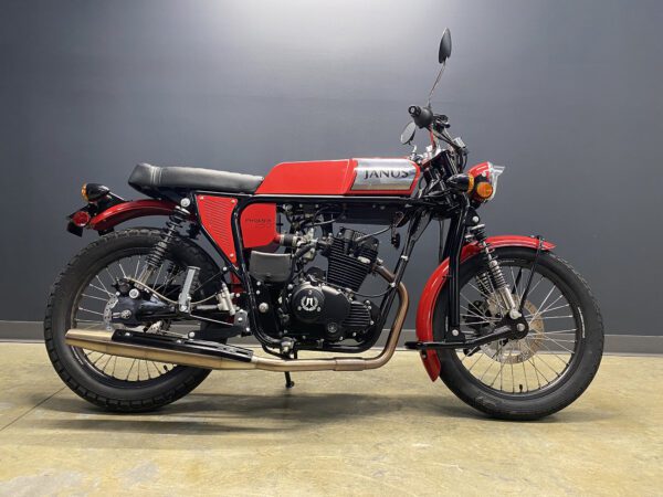 Red Janus Phoenix 250 classic motorcycle on display with gray background.