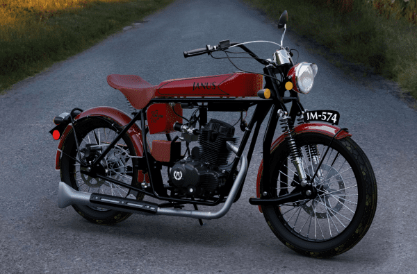 Red vintage motorcycle parked on a countryside road.