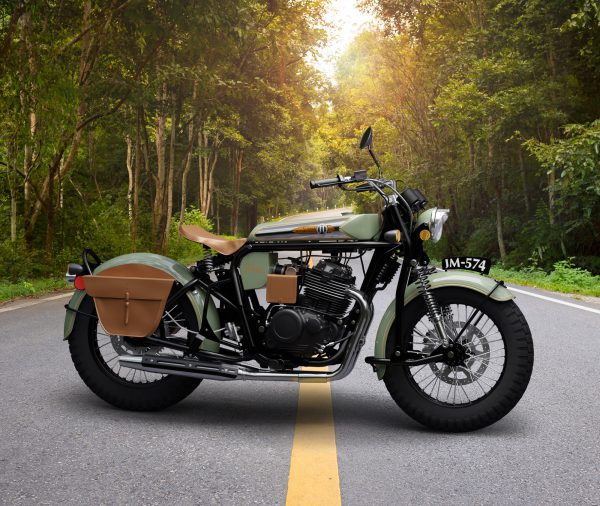 Vintage motorcycle parked on a forest road at sunset.