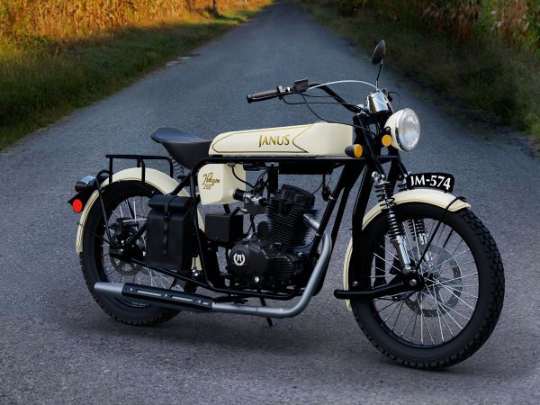 Vintage Janus motorcycle parked on a rural road at sunset.